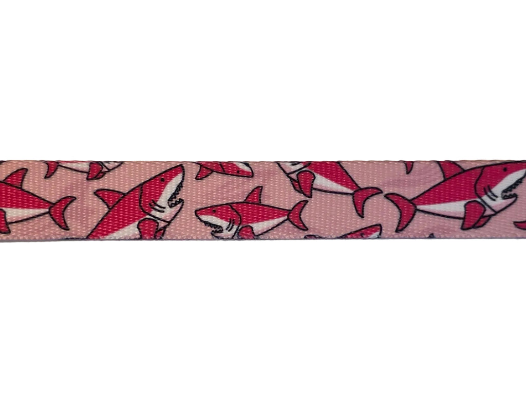 Polyester webbing with shark pattern on a light pink background