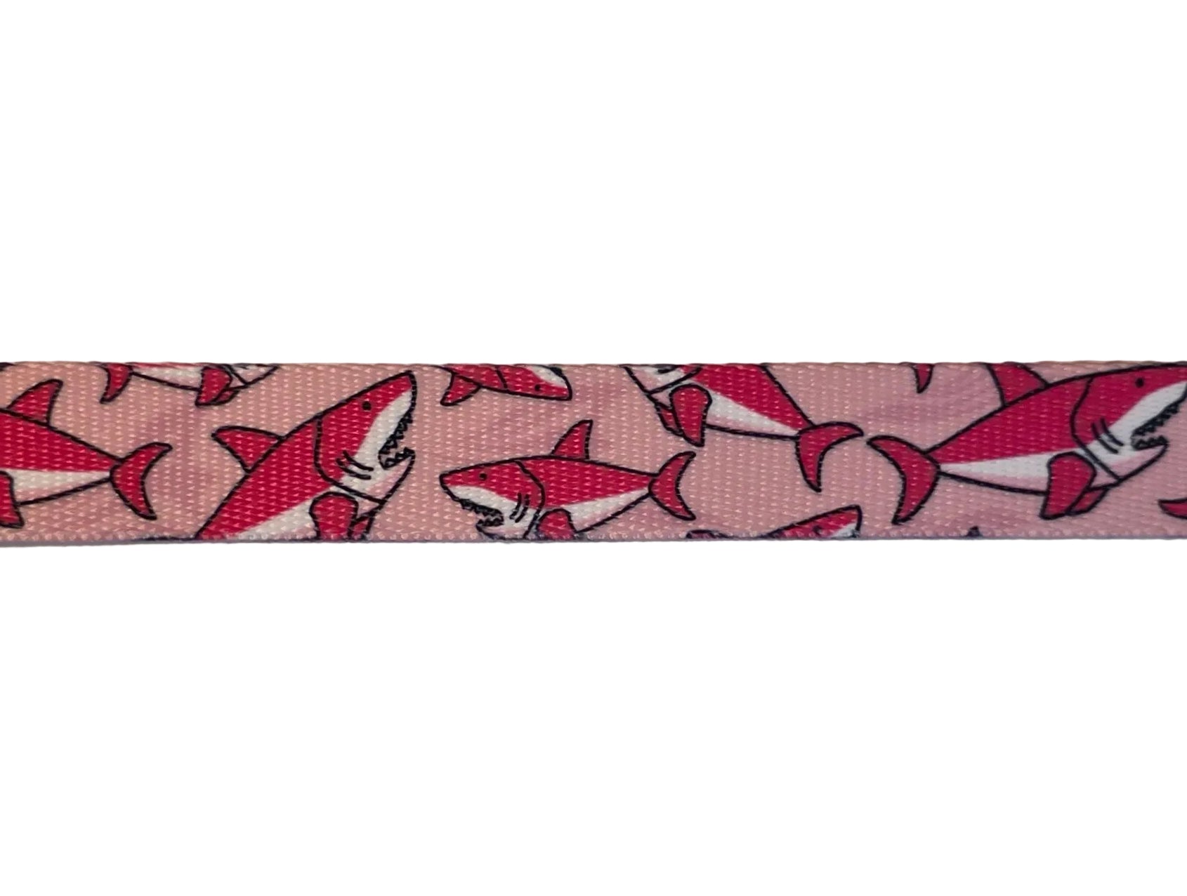Polyester webbing with shark pattern on a light pink background